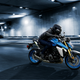 Blue and silver motorcycle riding in a tunnel.
